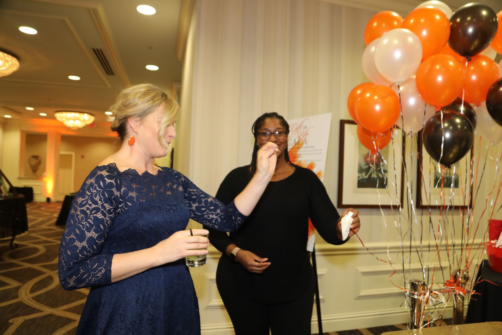 Annette Hall pops balloon